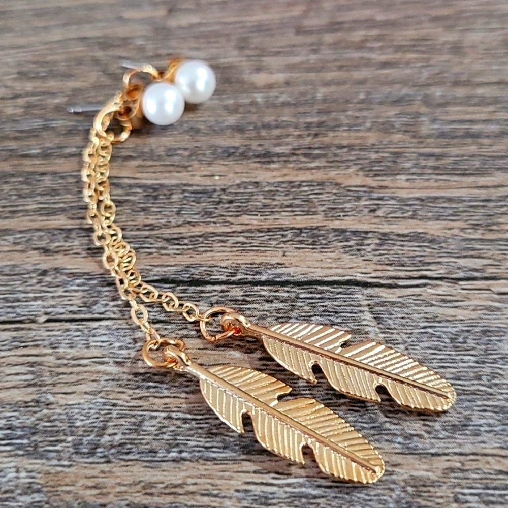 Long gold tone earrings feather